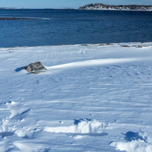 Snow Mountains - Serene winter scene of a snow-covered shoreline  #11138875