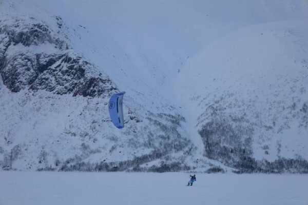 Snow Mountains - A thrilling snowkiting experience against the sn #11302800