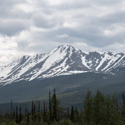 Snow Mountains - Snow-capped mountain under cloudy sky in Alberta #12597229