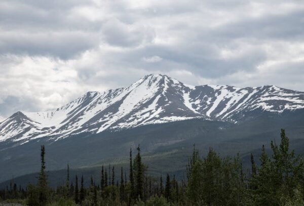 Snow Mountains - Snow-capped mountain under cloudy sky in Alberta #12597229