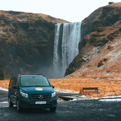 Lake Reflections - A tranquil view of a camper van parked near a ma #17301234