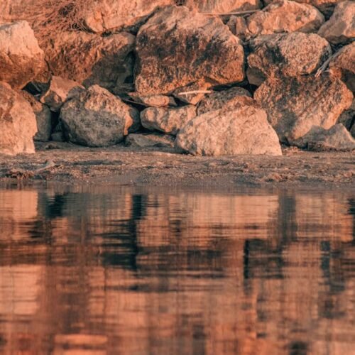 Beach Scenery - Tranquil reflection of rocky shoreline at Urla,  #19887119