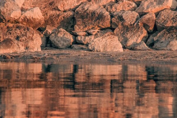 Beach Scenery - Tranquil reflection of rocky shoreline at Urla,  #19887119