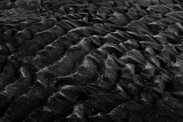 Desert Wilderness - Close-up of textured black sand dunes in monochr #2387818