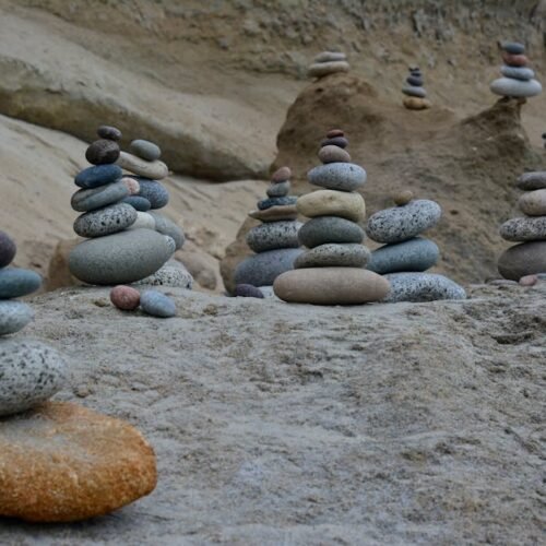Beach Scenery - Tranquil scene of balanced stone stacks on a roc #26752990
