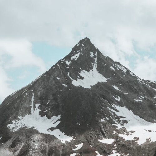 Snow Mountains - Stunning view of a rugged, snow-dotted mountain  #27240701