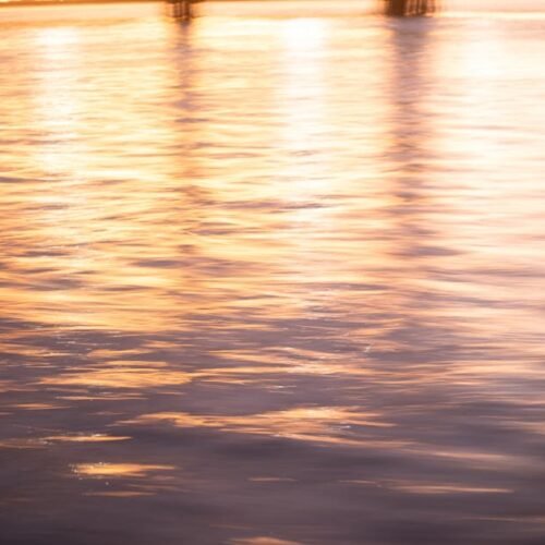Lake Reflections - Golden sunset light reflecting on tranquil water #27935406