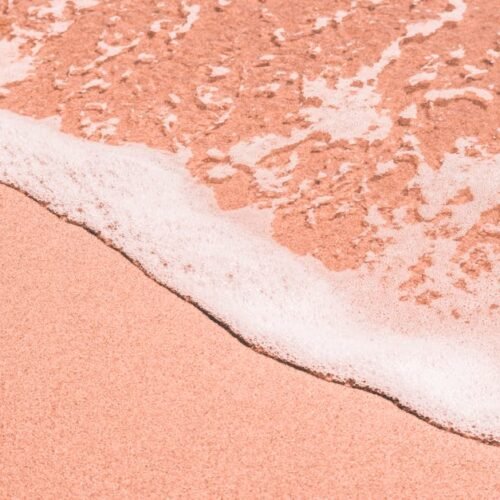 Beach Scenery - Close-up of a pink sandy beach as gentle sea foa #2877188