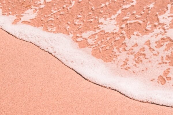 Beach Scenery - Close-up of a pink sandy beach as gentle sea foa #2877188