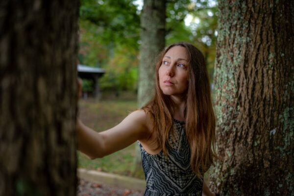 Forest Nature - A thoughtful woman stands among trees in an autu #28818666