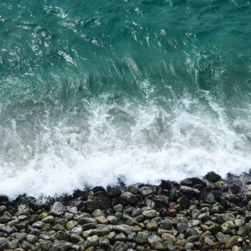 Beach Scenery - Aerial view of turquoise waves crashing on rocks #29520173