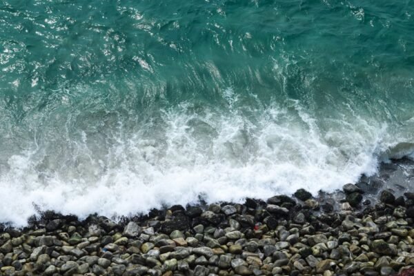Beach Scenery - Aerial view of turquoise waves crashing on rocks #29520173