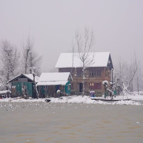 Lake Reflections - A serene winter scene of snow-covered homes by a #30093606