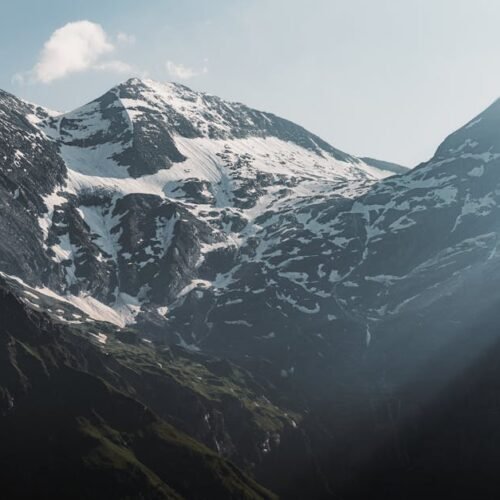 Mountain Landscapes - Stunning view of snow-covered peaks under dramat #33426403