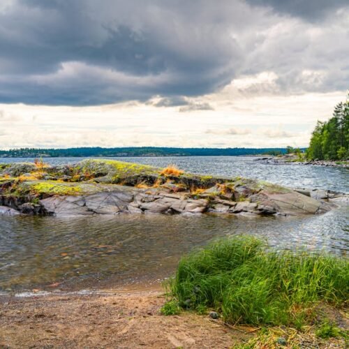 Lake Reflections - Beautiful view of a stone island and lush greene #33498332