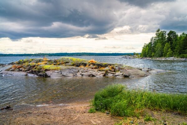 Lake Reflections - Beautiful view of a stone island and lush greene #33498332