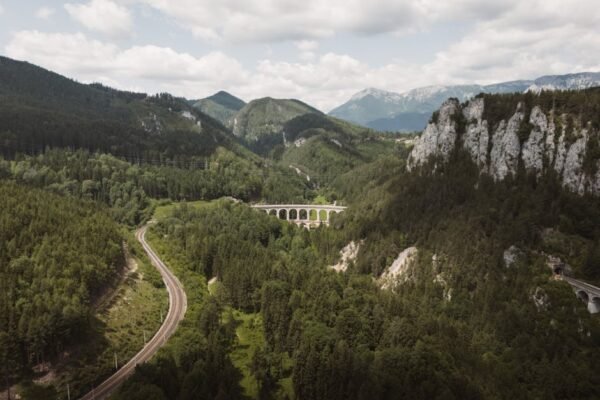 Mountain Landscapes - Stunning aerial view of alpine viaduct and lush  #33632865