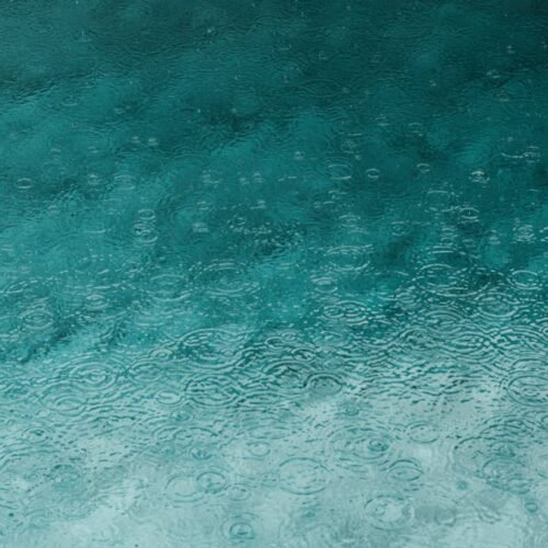 Desert Wilderness - Serene teal water surface with ripples and raind #3394939