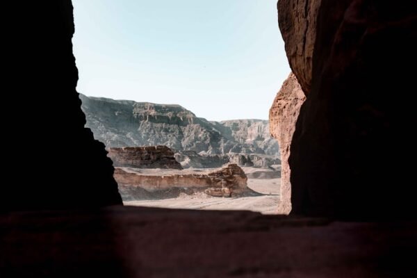 Desert Wilderness - Scenic view of a desert canyon from a rocky cave #3416666