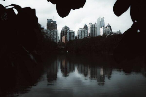 Lake Reflections - A serene view of a city skyline reflected in the #35420316