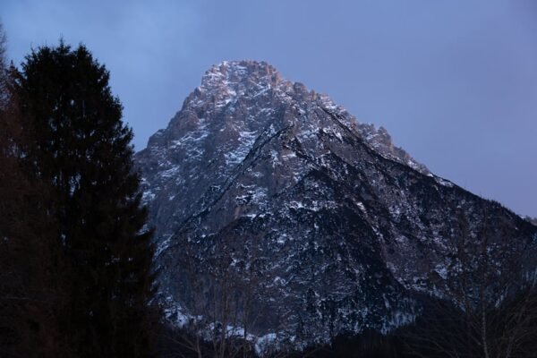 Snow Mountains - Majestic snow-capped mountain with dark trees ca #36211322