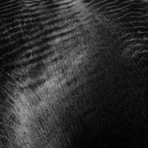 Desert Wilderness - Detailed close-up of a black sand texture with s #3709433