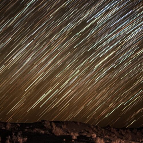 Desert Wilderness - Captivating long exposure of star trails over an #7459817