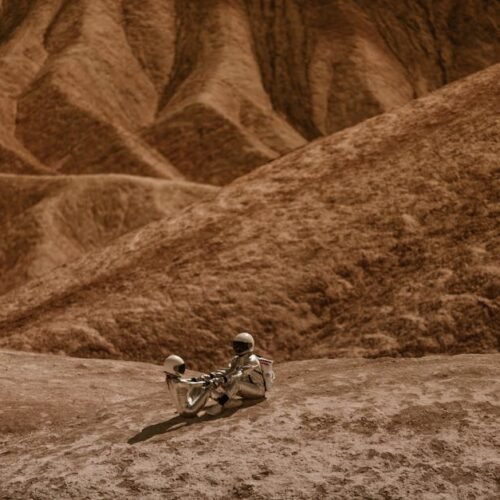 Desert Wilderness - Astronauts in suits sitting on rugged, Mars-like #8474420 Desert Wilderness - Astronauts in suits sitting on rugged, Mars-like #8474420