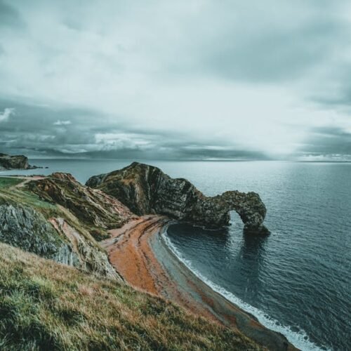 Beach Scenery - Scenic view of Durdle Door arch along the Jurass #8567869