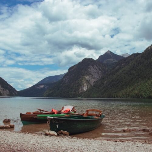 Lake Reflections - Scenic view of boats docked by a serene lake sur #9468391